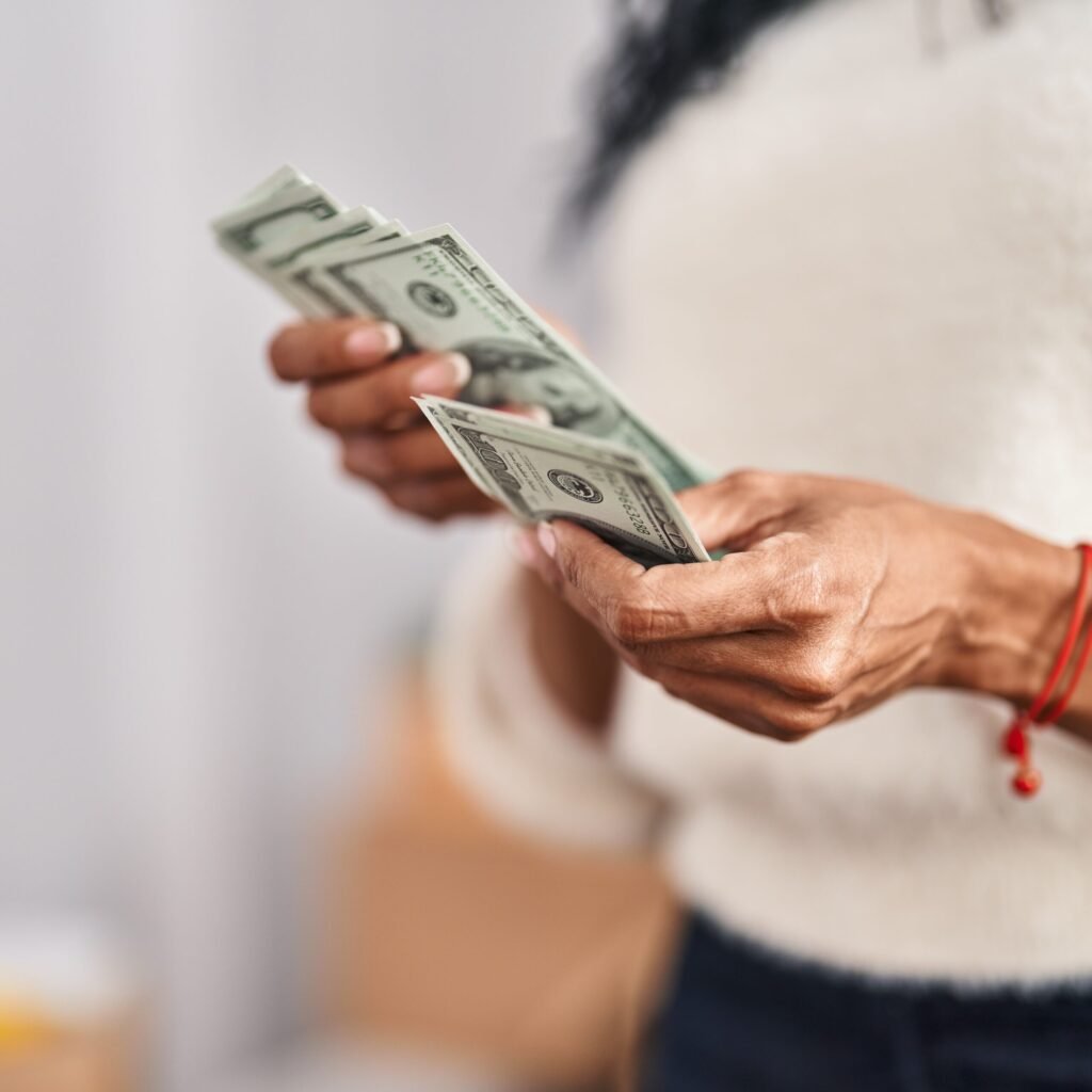 African american woman counting dollars at new home African american woman counting dollars at new home