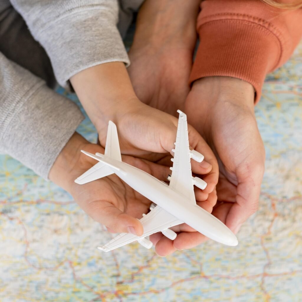 mother-child-home-holding-airplane-figurine-top-map mother-child-home-holding-airplane-figurine-top-map
